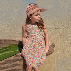 Detail of baby girl floral sleeveless summer dress and pink open top sun visor hat