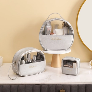 Three-piece set of silver metallic makeup bags with transparent windows for travel