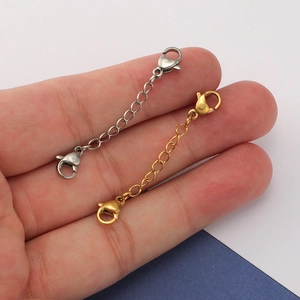 Detail of gold and silver stainless steel extender chains with dual lobster clasps