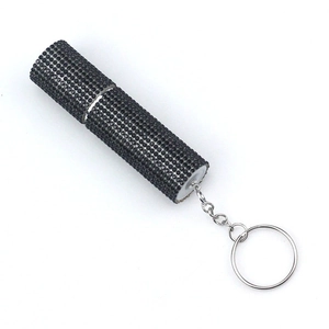 Macro shot of sparkling black rhinestones on a portable refillable perfume bottle keychain