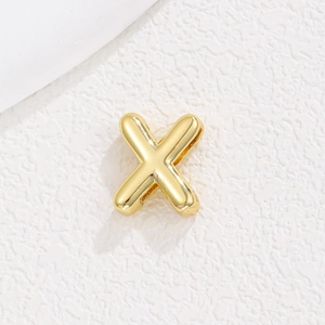 Detailed close-up of a 10mm gold-plated X alphabet bead for DIY charm bracelets