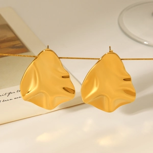 Detailed view of 18k gold hammered texture irregular earrings with liquid metal design
