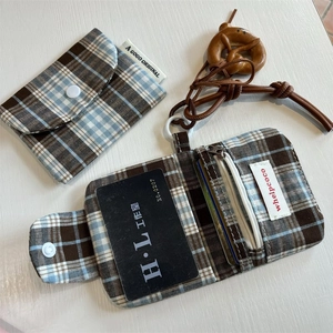 Detail view of woven check card holder with zip pocket and wooden pretzel charm