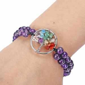 Detail view of double-layer purple beaded bracelet with silver Tree of Life charm