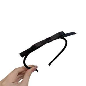 Elegant black fabric bow headband for women with slim design and glossy satin finish