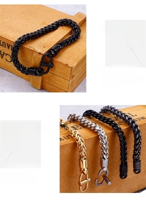 Detail of multi-color dragon bone link bracelets with U-shaped clasps on wood background