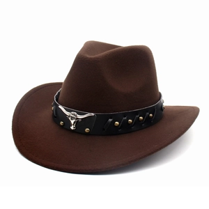 Detail of dark brown cowboy hat featuring silver bull head emblem and gold studs