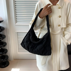 Close-up of black quilted nylon hobo bag with zipper closure and single shoulder strap