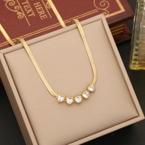 Gold snake chain necklace with five heart-shaped cubic zirconia pendants in a gift box