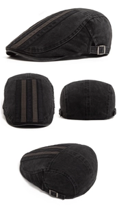 Macro detail of washed gray beret featuring three parallel stripes and metal side buckle