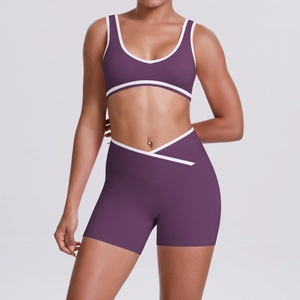 Detail of high-waisted crossover purple yoga shorts with white contrast trimming