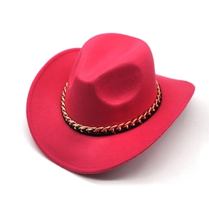 Detail of hot pink western cowboy hat featuring thick felt texture and gold chain trim
