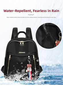 Waterproof detail of black nylon backpack with golden zippers and bear charm pendant