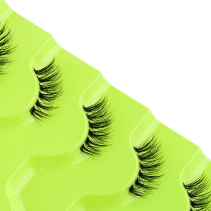 Macro detail of natural half false eyelashes in a bright neon green display tray
