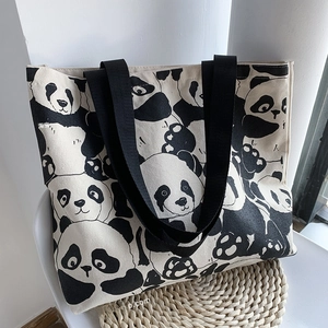 Close-up of cute panda pattern print on durable off-white canvas tote bag material