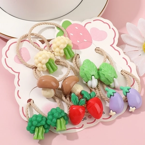Cute vegetable hair ties for girls with broccoli carrot and mushroom charms on pink background