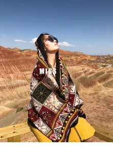 Outdoor close-up of bohemian ethnic print shawl against scenic red rock mountains