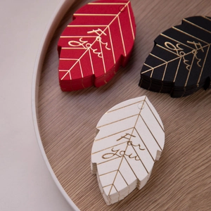 Leaf-shaped paper gift tags with gold foil For You lettering in red black and cream