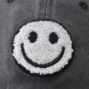 Washed vintage baseball cap in charcoal grey with classic towel embroidered smiley patch