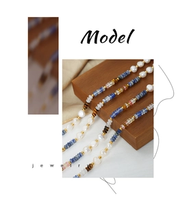 Detailed shot of bohemian beaded necklace with natural pearls and blue gemstone beads