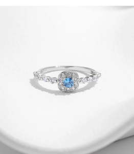 Macro view of square blue sapphire ring in 925 sterling silver with halo diamonds
