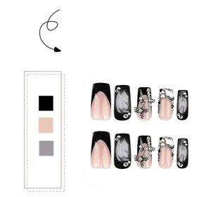 Close-up of black French press-on nails with 3D silver crosses and pearl accents