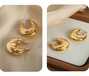 Detailed view of vintage gold-plated U-shaped earrings with intricate floral relief texture