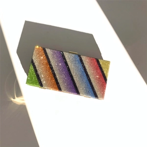Macro shot of colorful rhinestone clutch showing sparkling rainbow stripes and top clasp