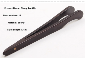 Detail view of 17cm ebony wood tea tweezers featuring smooth dark wood grain texture