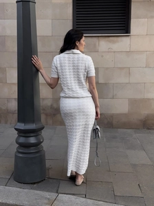 Rear view of white knit polo top and cutout maxi skirt set showing fit and texture