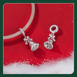 Detail of S925 sterling silver Christmas bell charm with pink bow on snake chain
