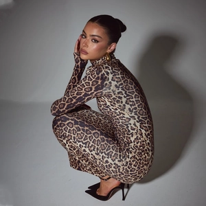 Close-up of leopard print bodysuit featuring a high neckline and long sleeves fabric
