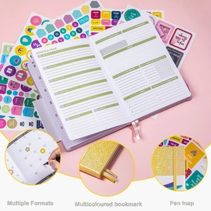 Detail of weekly planner pages featuring stickers, bookmarks, and a pen loop holder