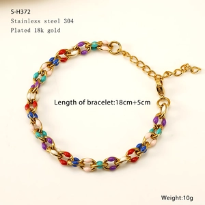 Macro shot of 18K gold plated Cuban link chain with colorful enamel drip details