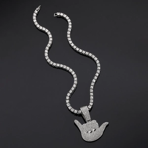 Close-up of hip hop tennis chain with iced out Shaka hand gesture pendant and crystals