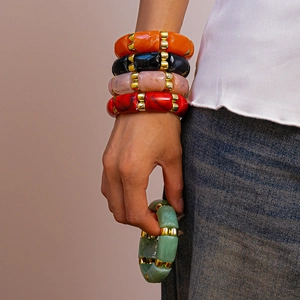 Detailed view of colorful acrylic beads with golden metal spacers in a retro stack design
