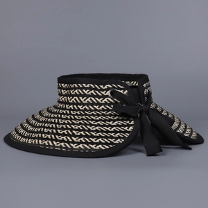 Detail of striped woven sun visor featuring a black bow and metallic eyelet decoration