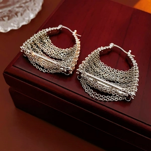 Close-up of silver metal tassel chain earrings displayed on a dark red jewelry box