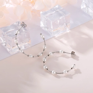 Elegant C-shaped pearl hoop earrings with silver metal wire and glossy white pearls