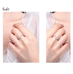 Detailed view of silver star ring with zircon accents on a model wearing white lace