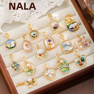 Detailed macro of vintage enamel pendants with baroque pearls and gold plating