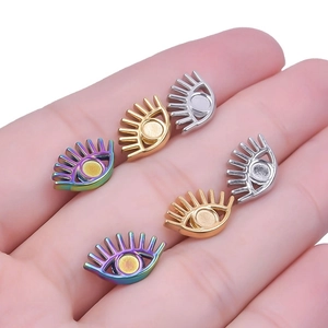 Detailed view of 304 stainless steel eye-shaped earring charms in gold, silver and rainbow