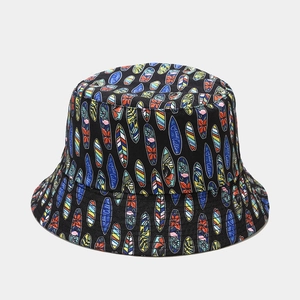 Detail of black cotton bucket hat featuring colorful surfboard print and Ocean Calling text