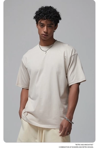 Detail of apricot oversize cotton t-shirt featuring relaxed drop shoulders and premium knit texture