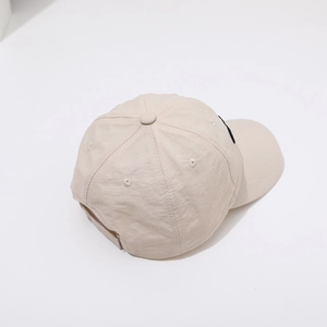 Detalle de la corona de gorra de béisbol beige en nailon de secado rápido y seis paneles