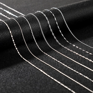 Detail of seven silver necklace chains showing box, wave, and cable link styles