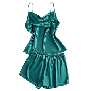 Emerald green satin sleepwear set featuring camisole top and elastic shorts