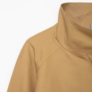 Women's khaki short trench coat with stylish stand collar and raglan sleeve construction
