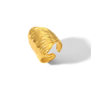 Detail shot of golden hammered texture on stainless steel open ring with metal luster
