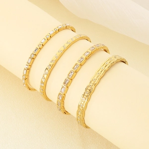 Detailed view of four 18K gold plated stainless steel bangles with sparkling zircon stones